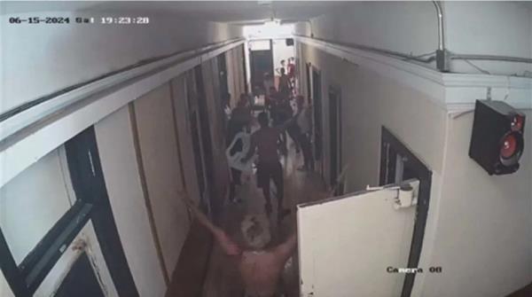 A hallway in the Gateway Hotel filled with people.