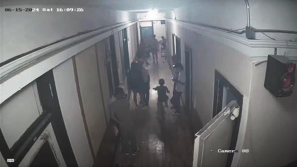 Surveillance video shows grown men and children lingering in the hallway of the Gateway Hotel in El Paso.